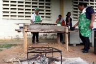 Volunteers help to prepare the meal for students at the San Agustin school in La Canada de Urdaneta