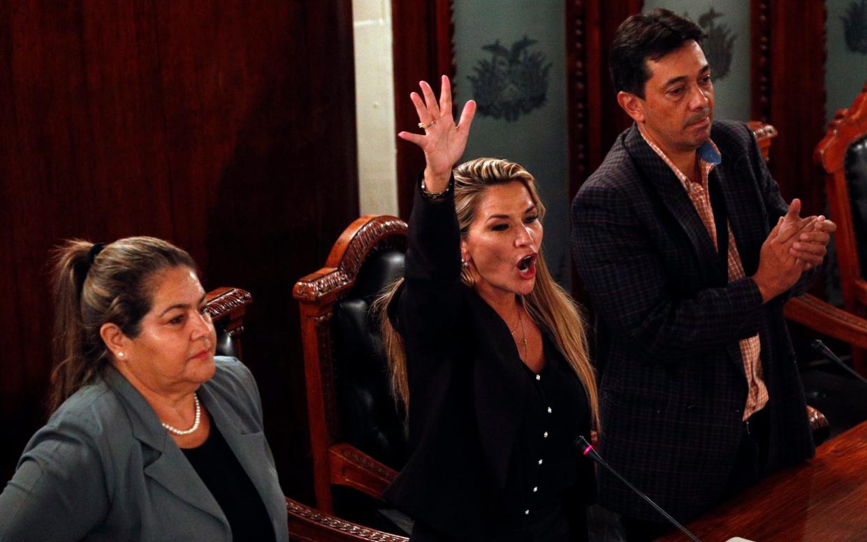 Deputy speaker Jeanine Anez, centre, assumes the presidency in La Paz on Tuesday - AP