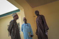 Parents of missing schoolgirls wait for news of the more than 300 girls who were abducted by gunmen on Friday from the Government Girls Junior Secondary School, in Jangebe town, Zamfara state, northern Nigeria Sunday, Feb. 28, 2021. Families in Nigeria waited anxiously on Sunday for news of their abducted daughters, the latest in a series of mass kidnappings of school students in the West African nation. (AP Photo/Ibrahim Mansur)