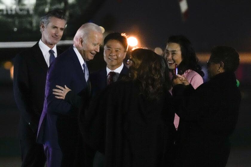 President Joe Biden arrives at Santa Monica Airport in Santa Monica, Calif., Friday, Dec. 8, 2023. Rep. Ted Lieu, D-Calif., third from left, and California Gov. Gavin Newsom, left, and Los Angeles Mayor Karen Bass, right, look on. (AP Photo/Manuel Balce Ceneta)