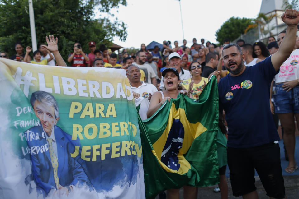 Supporters of former lawmaker Roberto Jefferson protest against his arrest next to his house in Levy Gasparian, Rio de Janeiro state, Brazil, Sunday, Oct. 23, 2022. Jefferson, an ally of Brazilian President Jair Bolsonaro, fired gunshots and a grenade at federal policemen who tried to arrest him in for insulting supreme court ministers, according to Brazil’s federal police. (AP Photo/Bruna Prado)