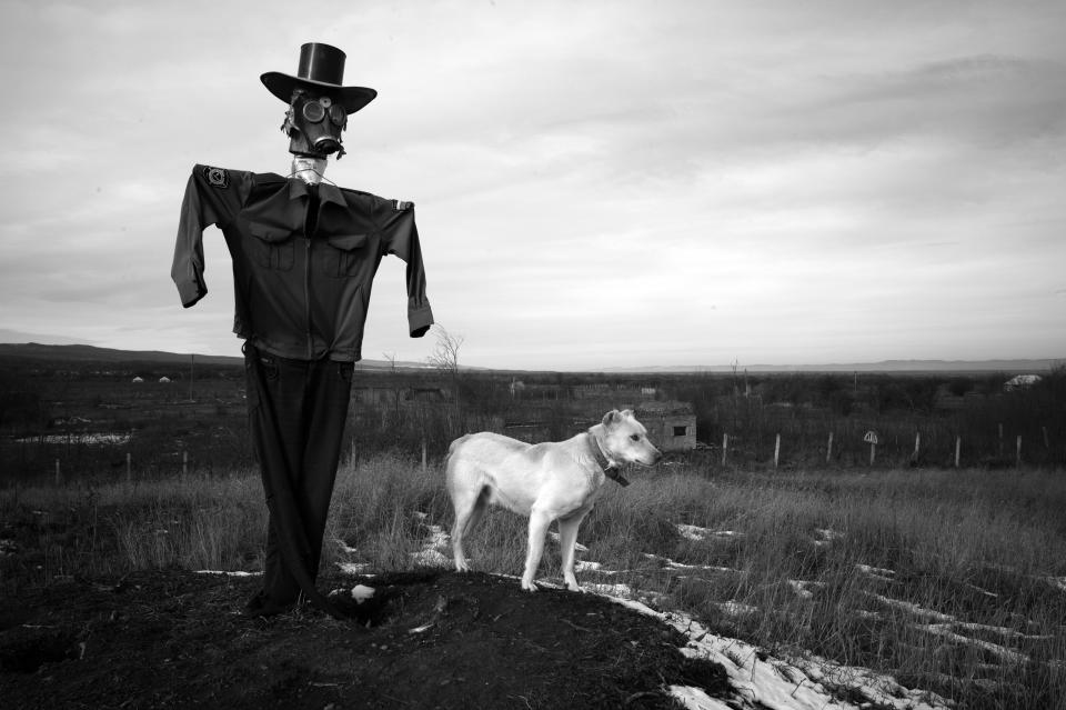 <p>“Hidden Scars”: Bamut, Chechnia, 2013. A scarecrow and his guard dog watch over the village of Bamut, which was always a rebel stronghold, and was the last village to fall to Russian forces. The entire village was leveled by the Russian military. Bamut is near the Chechen border with neighboring Ingushetia, which lies to the west of Chechnya. In April 2014, Chechen President Ramzan Kadyrov sent forces on a cross-border raid into Ingushetia. A few years previously, he sent forces on a similar raid into Dagestan, to the east. Kadyrov’s Pan-Caucasus ambitions are making his neighbors uneasy. (© Stanley Greene/Noor Images from “War Is Only Half the Story,” the Aftermath Project & Dewi Lewis Publishing) </p>