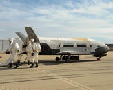 Recovery crew members process the X-37B Orbital Test Vehicle at Vandenberg Air Force Base last year after mission complete.