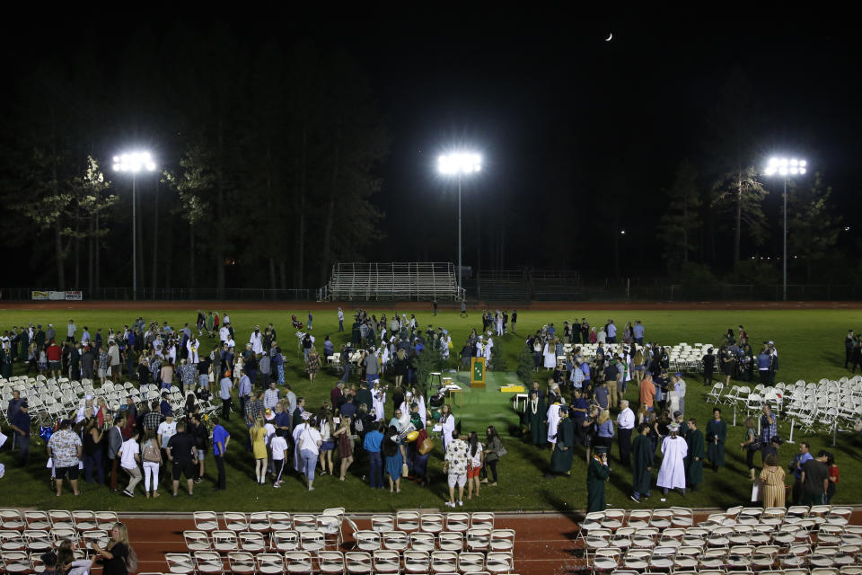 Graduating seniors gather with family and friends after the graduation ceremonies at Paradise High School in Paradise, Calif., Thursday June 6, 2019. Most of the students of Paradise High lost their homes when the Camp Fire swept through the area and the school was forced to hold classes in Chico. The seniors gathered one more time at Paradise High for graduation ceremonies. (AP Photo/Rich Pedroncelli)