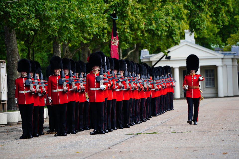 Members of the Coldstream Guards leave Wellington Barracks ahead of the ceremonial procession of the coffin of Queen Elizabeth II from Buckingham Palace to Westminster Hall, in central London, Wednesday, Sept. 14, 2022. (Ben Birchall/Pool via AP)