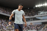 Spain's Carlos Alcaraz walks back to the baseline in his first round match against Argentina's Juan Ignacio Londero at the French Open tennis tournament in Roland Garros stadium in Paris, France, Sunday, May 22, 2022. (AP Photo/Christophe Ena)