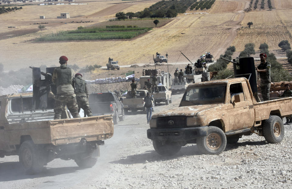 Turkey-backed FSA fighters are heading toward Syrian town of Tal Abyad from Turkish border town of Akcakale, Turkey, Thursday, Oct. 10, 2019. Turkish President Recep Tayyip Erdogan says that there have been 109 "terrorists killed" — a reference to Syrian Kurdish fighters — since Ankara launched an offensive into Syria the previous day. (DHA via AP)