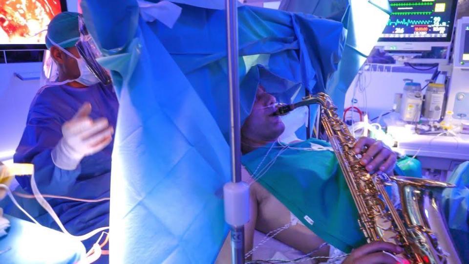  A photo provided by the Paideia International Hospital in Rome, Italy, shows a 35-year-old male patient playing the saxophone as he has open brain surgery to remove a tumor, October 10, 2022. / Credit: Courtesy of Paideia International Hospital