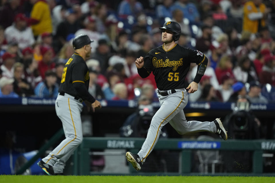 Pittsburgh Pirates' Jason Delay (55) scores off a double hit by Jared Triolo during the third inning of a baseball game against the Philadelphia Phillies, Thursday, Sept. 28, 2023, in Philadelphia. (AP Photo/Matt Rourke)