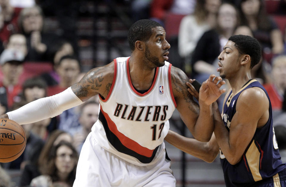 Portland Trail Blazers forward LaMarcus Aldridge, left, looks for an opening against New Orleans Pelicans forward Anthony Davis during the first half of an NBA basketball game in Portland, Ore., Sunday, April 6, 2014. (AP Photo/Don Ryan)