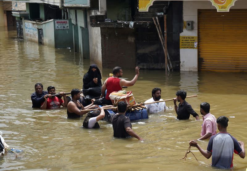 Residents are evacuated from a flooded neighbourhood after heavy rainfall in Hyderabad