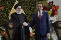 Iran's President Ebrahim Raisi, left, shakes hands with Indonesian President Joko Widodo after a joint press conference at the Presidential Palace in Bogor, West Java, Indonesia, Tuesday, May 23, 2023. (AP Photo/Achmad Ibrahim)