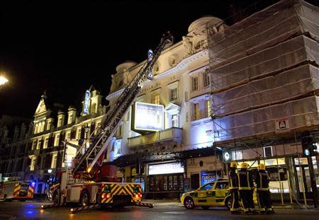 Emergency services look at the roof of the Apollo Theatre on Shaftesbury Avenue after part of the ceiling collapsed in central London December 19, 2013. REUTERS/Neil Hall