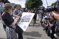 Katie Mahoney, left, and Rev. Patrick Mahoney, chief strategy officer for Stanton Healthcare, an Idaho-based pregnancy center that does not provide abortions, read the text of a Supreme Court decision outside the Supreme Court on Thursday, June 27, 2024, in Washington. The Supreme Court cleared the way Thursday for Idaho hospitals to provide emergency abortions for now in a procedural ruling that left key questions unanswered and could mean the issue ends up before the conservative-majority court again soon. (AP Photo/Mark Schiefelbein)