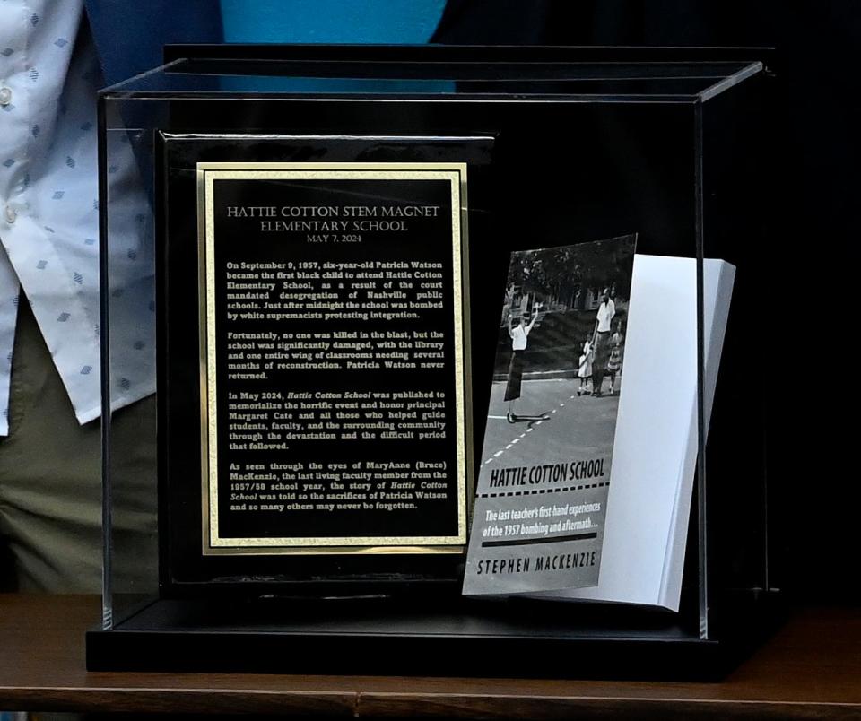 A plaque and a book by authors MaryAnne and Stephen MacKenzie of the book “Hattie Cotton School: The last teacher’s first-hand experiences of the 1957 bombing and aftermath” on display at Hattie Cotton STEM Elementary School on Tuesday, May 7, 2024, in Nashville, Tenn.