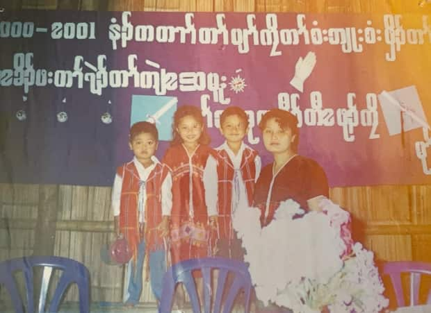 Kamwee Eh poses for a picture with her brothers and mom when she was a child.