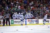 The Toronto Maple Leafs leave their bench during the third period of an NHL hockey game after fans starting throwing objects onto the ice after three New Jersey Devils goals had been disallowed, Wednesday, Nov. 23, 2022, in Newark, N.J. The Maple Leafs won 2-1. (AP Photo/Adam Hunger)