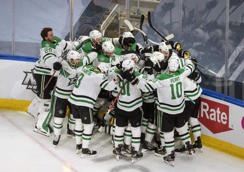 Dallas Stars celebrate their win over the Colorado Avalanche during overtime NHL Western Conference Stanley Cup playoff game action in Edmonton, Alberta, Friday, Sept. 4, 2020. (Jason Franson/The Canadian Press via AP)