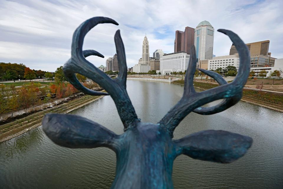 A bronze buck overlooks the Scioto River from the Rich Street bridge in downtown Columbus on Oct. 6, 2015.