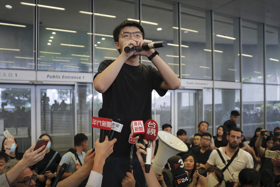 Pro-democracy activist Joshua Wong speaks to protesters near the Legislative Council in Hong Kong, Monday, June 17, 2019. Wong, a leading figure in Hong Kong's 2014 Umbrella Movement demonstrations, was released from prison on Monday and vowed to soon join the latest round of protests. (AP Photo/Kin Cheung)