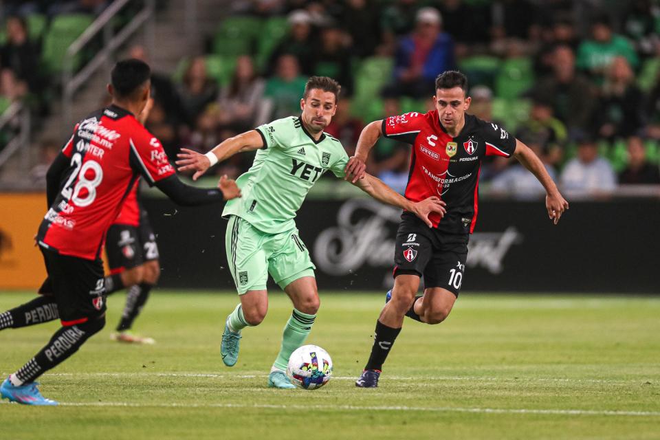 Austin FC midfielder Ethan Finlay, center, and Atlas FC midfielder Gonzalo Maroni, right, chase the ball during the teams' match at Q2 Stadium on Feb. 16. Finlay will face his former team, Minnesota United FC, on Sunday.