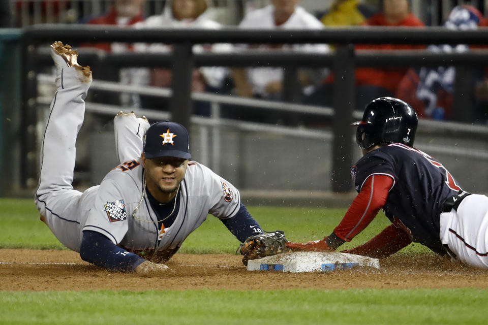 Houston Astros first baseman Yuli Gurriel forces out Washington Nationals' Trea Turner at first to end the seventh inning of Game 4 of the baseball World Series Saturday, Oct. 26, 2019, in Washington. (AP Photo/Patrick Semansky)