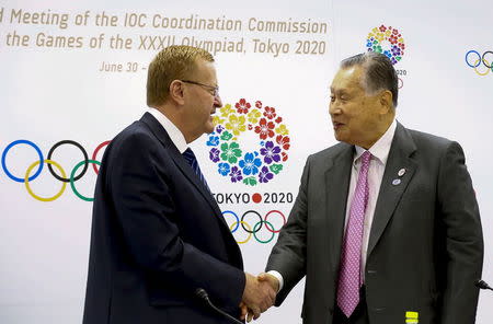 John Coates (L), International Olympic Committee (IOC) Chairman of the Coordination Commission for the Tokyo 2020 Games, shakes hands with Japan's organising committee President Yoshiro Mori after a news conference in Tokyo July 1, 2015. REUTERS/Thomas Peter