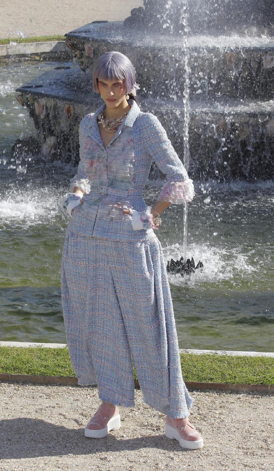 A model presents a creation by German fashion designer Karl lagerfeld for Chanel, Monday, May, 14, 2012. Master of Fashion, Karl Lagerfeld spares no expenses for his midseason Chanel Cruise show offering held at the former home of Marie Antoinette, the Chateau de Versailles, southwest of Paris. (AP Photo/Jacques Brinon)