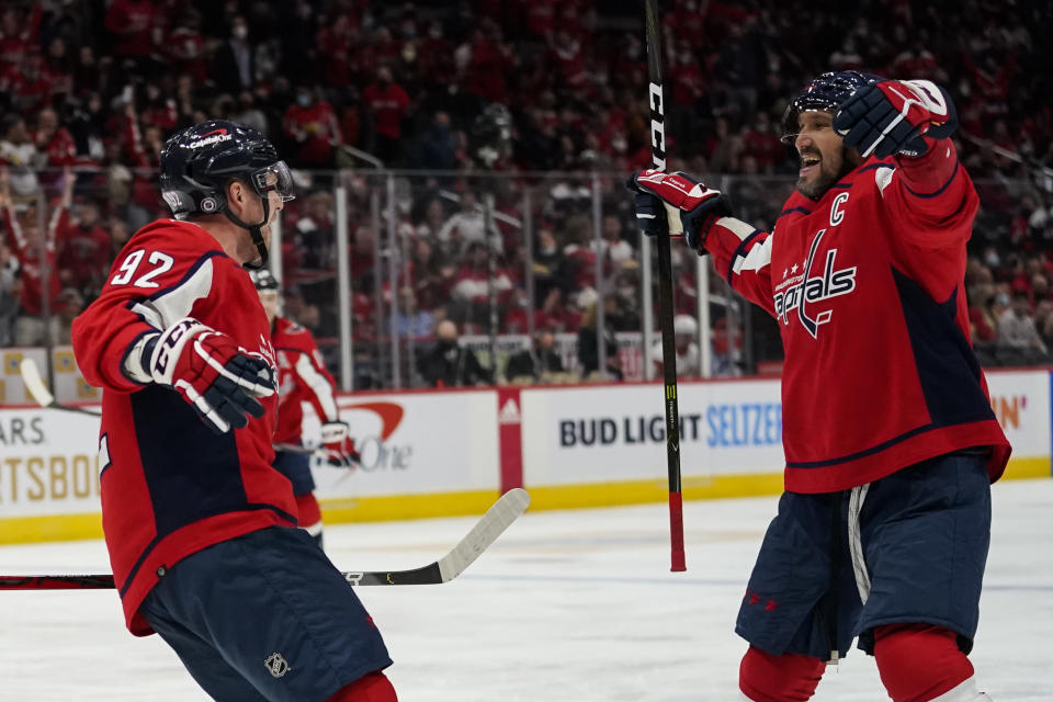 Washington Capitals center Evgeny Kuznetsov, left, celebrates his goal with left wing Alex Ovechkin in the second period of an NHL hockey game against the Detroit Red Wings, Wednesday, Oct. 27, 2021, in Washington. (AP Photo/Alex Brandon)