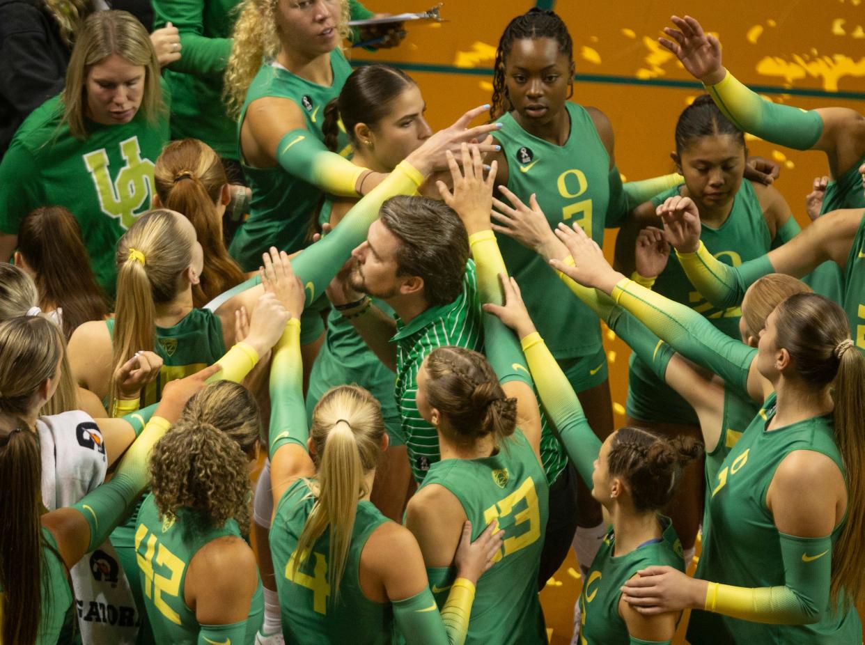 Oregon volleyball coach Matt Ulmer brings his team together during their match against Oregon State in Eugene Friday, Sept. 22, 2023.