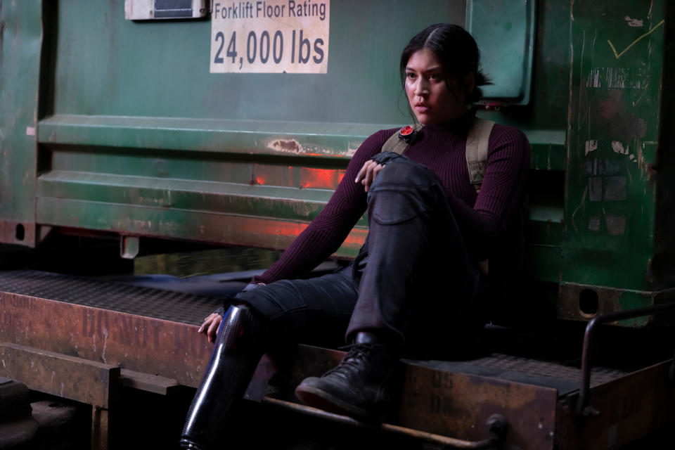 woman sitting at the edge of a forklife ramp