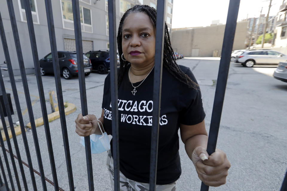 Roushaunda Williams poses for a photo in Chicago Thursday, July, 23, 2020. Financial challenges keep piling up for Williams months after she lost her job of nearly 20 years tending bar at the Palmer House Hilton Hotel in downtown Chicago. Potential reopening dates for the hotel have been pushed back, Williams said, and hospitality jobs remain scarce. (AP Photo/Nam Y. Huh)