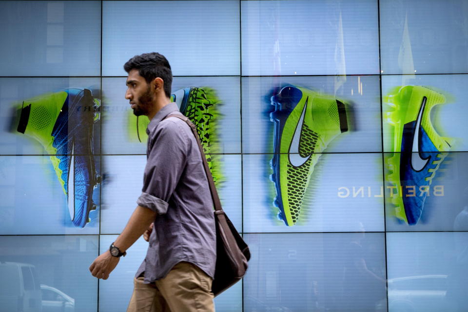 A man passes by the Niketown store in midtown Manhattan in New York June 25, 2015. Nike Inc, the world's largest footwear maker, reported a better-than-expected profit for the eighth quarter in a row as it sold more high margin basketball shoes and apparel at higher prices.  REUTERS/Brendan McDermid 