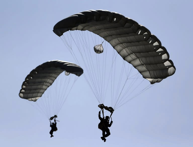Members of the United Arab Emirates' armed forces perform during the opening ceremony of the International Defence Exhibition and Conference (IDEX) at the Abu Dhabi National Exhibition Centre in the Emirati capital on February 17, 2013.