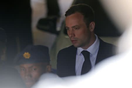South African Olympic and Paralympic sprinter Oscar Pistorius is led to a prison van after his sentencing in Pretoria October 21, 2014. REUTERS/Mike Hutchings