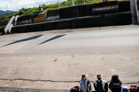 Venezuelans are pictured on the border with Venezuela, seen from the Brazilian city of Pacaraima, Roraima state, Brazil August 8, 2018. REUTERS/Nacho Doce
