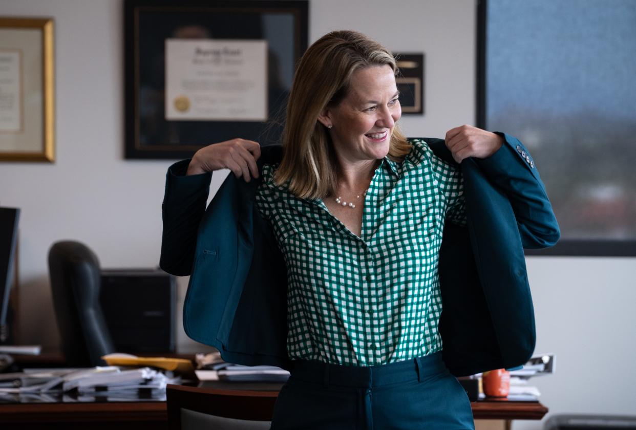 Attorney General Kris Mayes puts on her jacket ford an interview on March 14, 2023, in her office at 2005 N. Central Ave., in Phoenix.