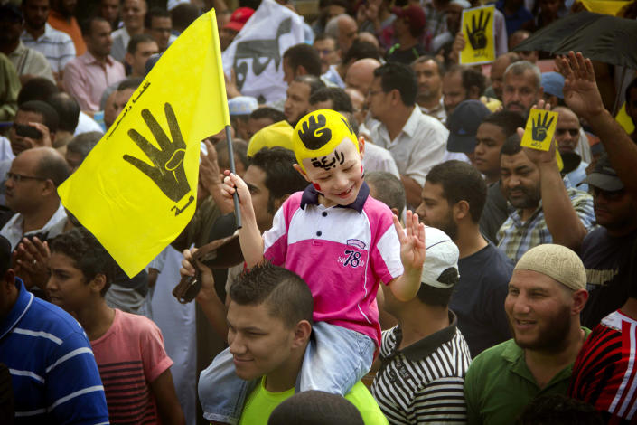 FILE - In this Friday, Sept. 27, 2013 file photo, A young Egyptian boy participates in a demonstration by supporters of ousted President Mohammed Morsi in the Maadi district of Cairo, Egypt. A court in southern Egyptian has convicted 529 supporters of ousted Islamist President Mohammed Morsi, sentencing them to death on charges of murdering a policeman and attacking police. (AP Photo/Hamada Elrasam, File)