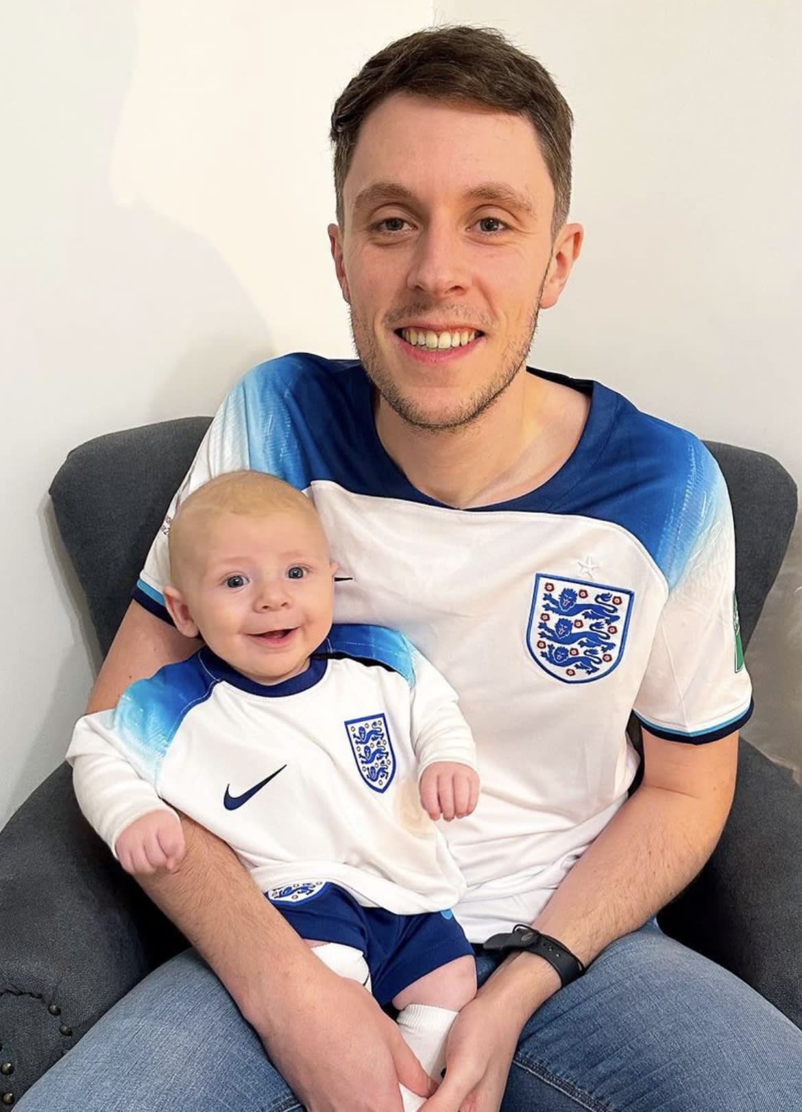 Jamie Nash pictured with his son who are both wearing England World Cup 2022 shirts