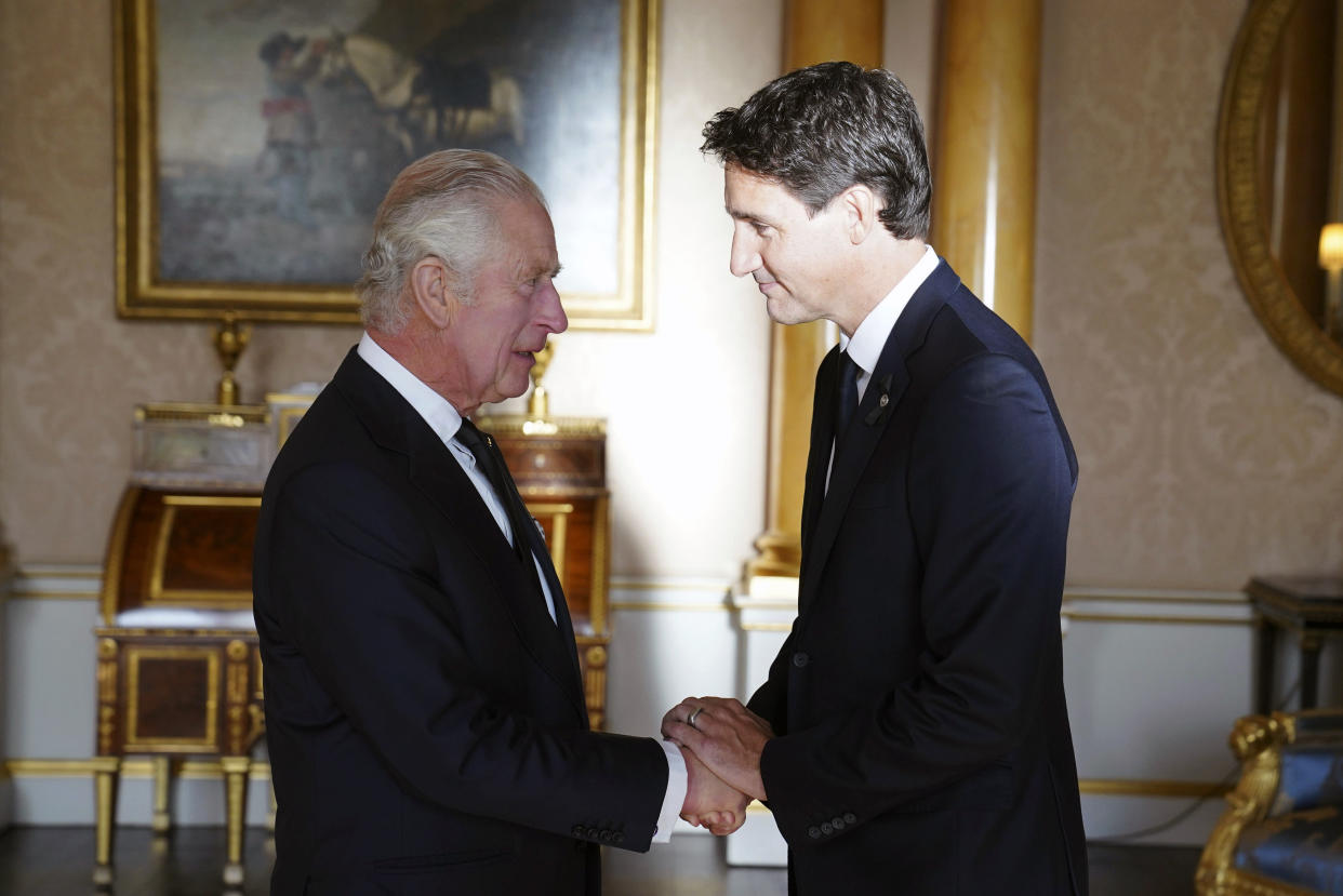 Britain's King Charles III shakes hands with Prime Minister of Canada Justin Trudeau, as he receives realm prime ministers in the 1844 Room at Buckingham Palace in London, Saturday, Sept. 17, 2022. (Stefan Rousseau/Pool via AP)