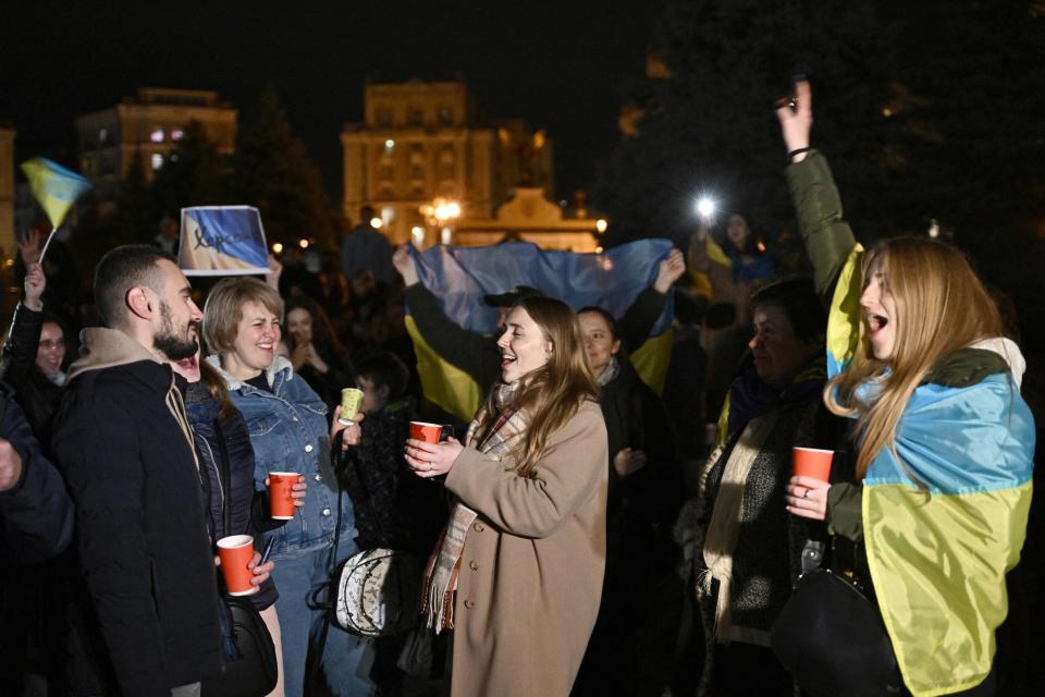 People gathered in Maidan Square to celebrate the liberation of Kherson, in Kyiv on 11 November 2022, amid the Russian invasion of Ukraine (AFP via Getty Images)