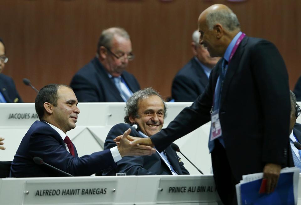 UEFA President Platini smiles as Al Rajoub, President of Palestinian Football Association, shakes hands with Prince Al Hussein of Jordan at the 65th FIFA Congress in Zurich