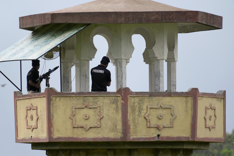 Police officers stand guard on the watch towers of district prison Attock, where Pakistan's former Prime Minister Imran Khan in-prison after his conviction, in Attock, Pakistan, Sunday, Aug. 6, 2023. Khan was arrested Saturday after a court handed him a three-year jail sentence for corruption, a development that could end his future in politics. (AP Photo/Anjum Naveed)