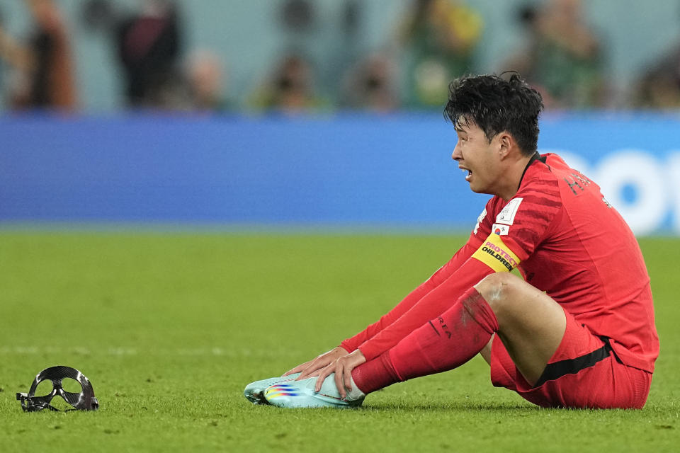 South Korea's Son Heung-min reacts after his team's 2-1 victory over Portugal at the end of the World Cup group H soccer match between South Korea and Portugal, at the Education City Stadium in Al Rayyan, Qatar, Friday, Dec. 2, 2022. (AP Photo/Ariel Schalit)