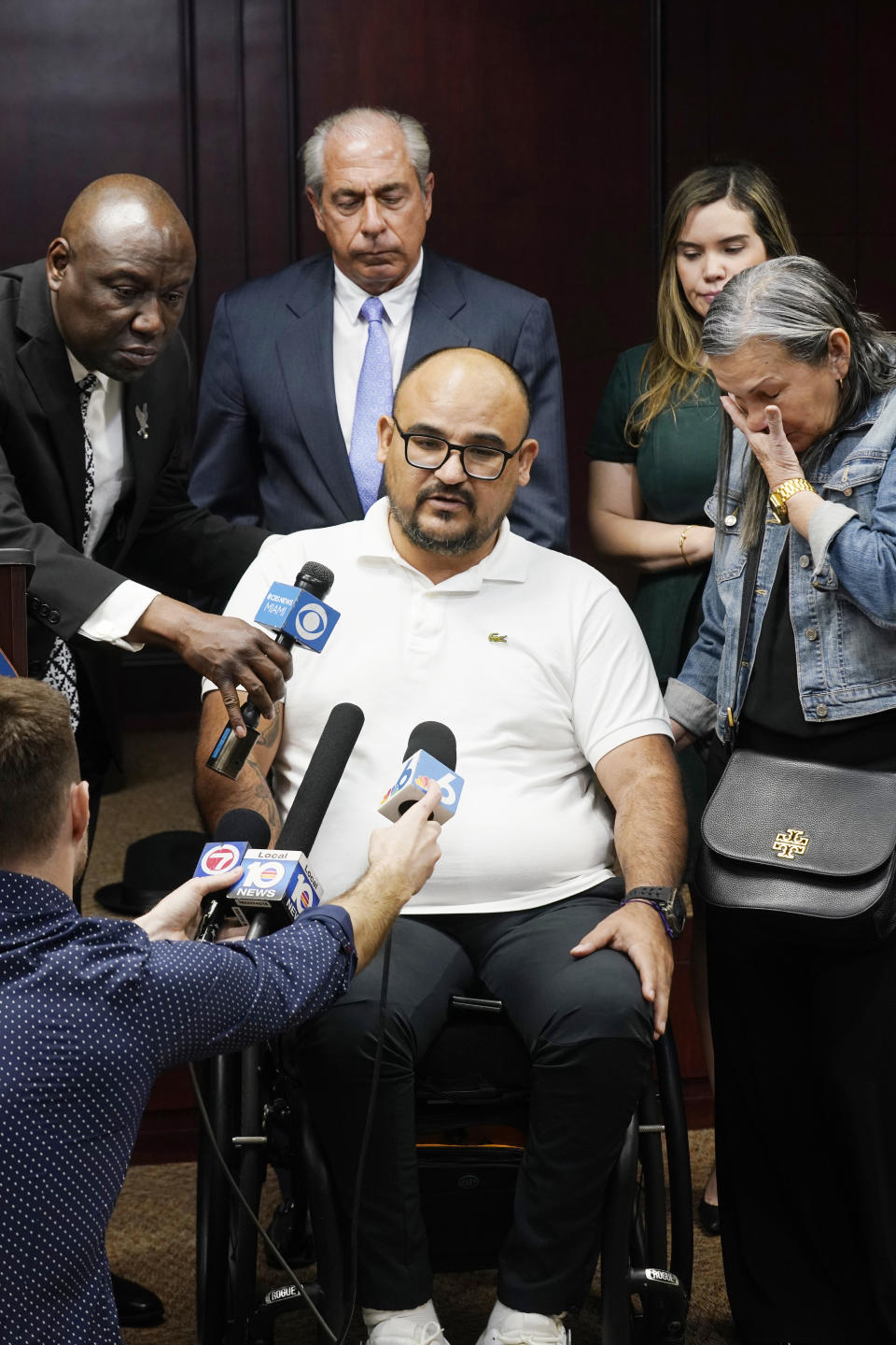 Michael Ortiz speaks at a news conference regarding a lawsuit against a police officer Wednesday, March 1, 2023, in Fort Lauderdale, Fla. Ortiz is suing after being paralyzed by a Hollywood, Fla., police officer who mistook his handgun for a taser and shot him in the back. Behind Ortiz are attorneys Ben Crump and Hunter Shkolnik. His mother Betty Ortiz is at right. (AP Photo/Marta Lavandier)