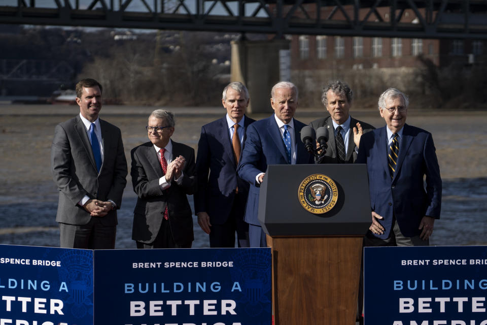 President Joe Biden (foreground) appears onstage with (from left) Kentucky Gov. Andy Beshear, Ohio Gov. Mike DeWine, former Ohio Sen. Rob Portman, Ohio Sen. Sherrod Brown and Kentucky Sen. Mitch McConnell on Jan. 4 in Covington, Ky. 