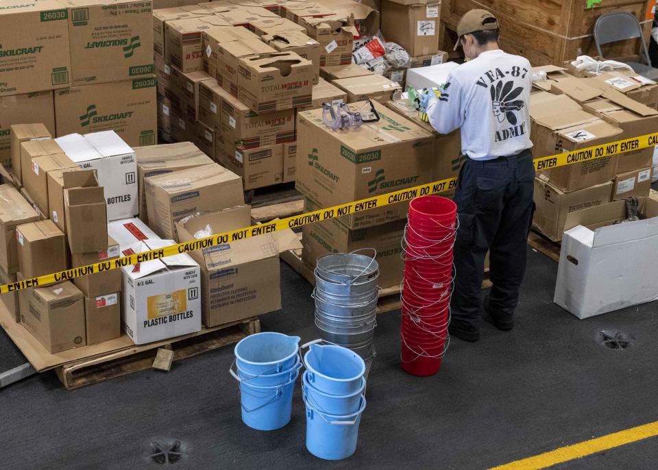 In this image provided by the U.S. Navy, U.S. Navy Yeoman 2nd Class Ryan Snortland, of Wildomar, Calif., assembles buckets of sanitizer for Sailors disinfecting the aircraft carrier USS Theodore Roosevelt (CVN 71) on April 15, 2020. The Navy’s top admiral will soon decide the fate of the ship captain who was fired after pleading for his superiors to move faster to safeguard his coronavirus-infected crew on the USS Theodore Roosevelt. (Mass Communication Specialist 1st Class Chris Liaghat/U.S. Navy via AP)