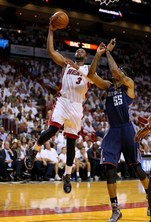 Dwyane Wade of the Miami Heat shoots past Chris Douglas-Roberts of the Charlotte Bobcats during Game Two of the Eastern Conference Quarterfinals at AmericanAirlines Arena on April 23, 2014