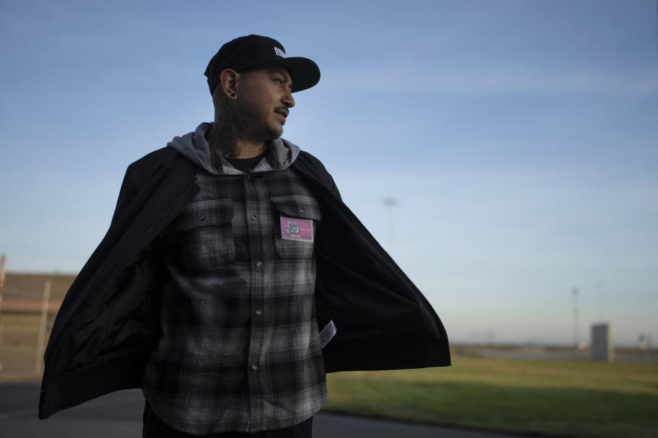 Rapper Bobby Gonzalez, a former prisoner at Valley State Prison, gets emotional as he enters the prison yard in Chowchilla, Calif., Friday, Nov. 4, 2022. Gonzalez was released on parole from the prison in September of 2019, after serving 16 years of a 25-year sentence as a juvenile offender. He left a mark at the prison and on the California Department of Corrections and Rehabilitation, emerging as an established artist by the name of "Bobby Gonz." (AP Photo/Jae C. Hong)