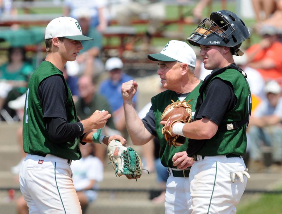 Central Catholic pitcher Joe Tann (left) meets with head coach Doug Miller and catcher Alex Grove during their 2011 state championship season.